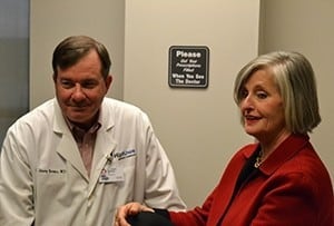 C. Lowry Barnes, M.D., chair of the UAMS Department of Orthopaedics, sits with his patient, Susan Smith