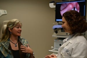 Deleen Davidson speaks with Ozlem Tulunay-Ugur, M.D., as an image of Davidson’s vocal cords is projected on the monitor.