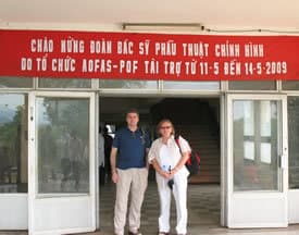 UAMS surgeon Ruth Thomas, M.D., and Boston surgeon Mark Slovenkai, M.D., pose outside a Vietnamese hospital during a recent medical mission. 