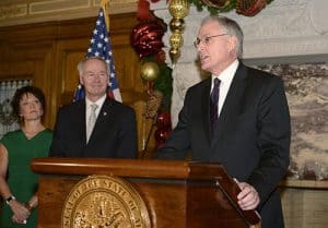 UAMS Chancellor Dan Rahn, M.D., celebrates the achievements of Michael Owens, Ph.D., (not shown) who was being named an Arkansas Research Alliance Fellow. Sonja Hubbard, chairman of the ARA board, and Gov. Asa Hutchinson look on during the news conference at the state Capitol.
