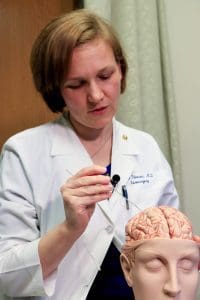UAMS neurosurgeon Erika Petersen, M.D. , demonstrates how she put the electrodes into Darius' brain during surgery.