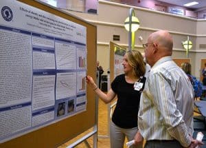 Amanda Bell, a student in the Clinical Nutrition program, presents her research to William Wessinger, Ph.D.