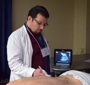Aziz Bakhous, M.D., of UAMS performs a kidney ultrasound on a standardized patient.