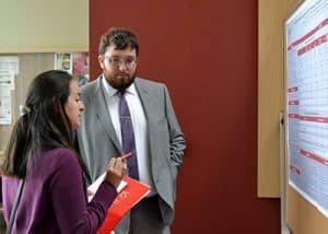 Brett Bailey, a student in the College of Pharmacy, presents his research on "Perceived motivating factors and barriers for the completion of postgraduate training among American pharmacy students" at Student Research Day.