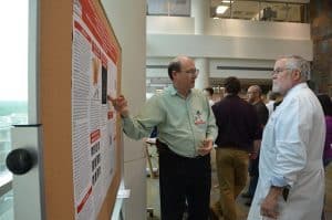 Michael Borelli, Ph.D., (left) discusses his research project with UAMS Graduate School Dean Robert McGehee, Ph.D.
