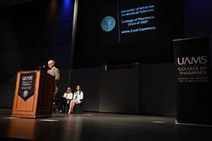 College of Pharmacy Dean Keith Olsen, Pharm. D., steps up to the podium at the Aug. 26 White Coat Ceremony. 