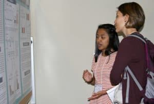 Student explaining research poster
