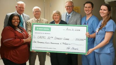 Delta Dental of Arkansas Foundation Executive Director Weldon Johnson, third from left, presented a ceremonial check to UAMS officials at the UAMS 12th Street Health and Wellness Center. Left to right, they are Lanita White, Pharm. D., center director; Dr. Robert Mason, board member, Delta Dental of Arkansas Foundation; Marcia Wheeler, D.D.S., assistant professor of dental hygiene in the UAMS College of Health Professions; Gene Jines, D.D.S., director, UAMS Center for Dental Education; John Pardo, D.D.S. and Alyssa Brailsford, D.D.S., dental residents, UAMS 12th Street Health and Wellness Center.