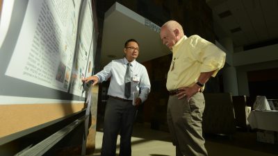 Researcher showing poster