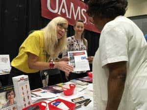 Two people at UAMS booth