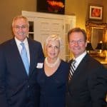 Chancellor Dan Rahn, M.D., with Margo and Chris Weiser, who opened their home for the inaugural Friends of UAMS – South.