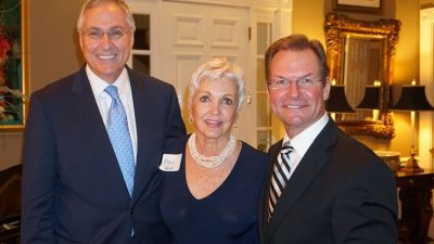 Chancellor Dan Rahn, M.D., with Margo and Chris Weiser, who opened their home for the inaugural Friends of UAMS – South.