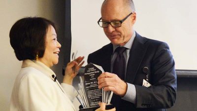 Jeanne Wei, M.D., Ph.D., receives the Distinguished Faculty Scholar award from Dean Pope L. Moseley, M.D.