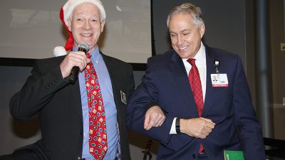 UAMS Chaplain George Hull (left) jokes around with Chancellor Dan Rahn, M.D., following Rahn's performance at the Hollydays concert on Dec. 2.