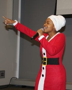 LaTasha Moore, a student in the Fay W. Boozman College of Public Health, sings "Have Yourself a Merry Little Christmas" during the Hollydays concert.