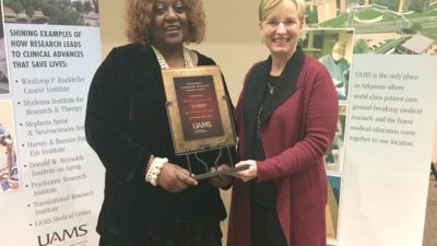 Naomi Cottoms received the Chancellor’s Community Research Partner Award on behalf of her organization, Tri County Rural Health Network, from TRI Director Laura James, M.D.