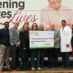 Members of the FIS campus leadership committee present a $25,000 check to the UAMS Mobile Mammography Program.