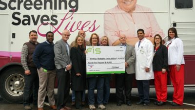 Members of the FIS campus leadership committee present a $25,000 check to the UAMS Mobile Mammography Program.
