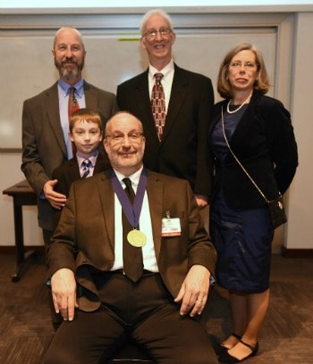 Ussery (seated) and his family at the investiture ceremony. With Dr. Ussery are his brother John and nephew Caden, brother Steve, and Dr. Ussery's wife, Colleen.