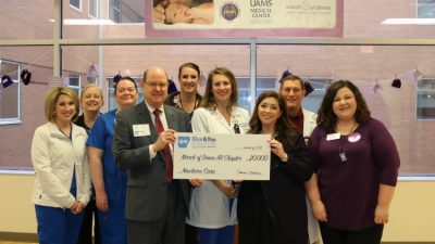 A $20,000 gift from the Blue & You Foundation to the Arkansas chapter of the March of Dimes will benefit the UAMS NICU. From left are UAMS’ Courtney Higginbotham, R.N., Ginny Smith, R.N., and Misty Williams, R.N.; Blue & You Foundation’s Patrick O’Sullivan; UAMS’ Emily Gordon and Rebekah Thacker, R.N.; March of Dimes’ Kristin Powell; UAMS’ Whitt Hall, M.D., and March of Dimes’ Rachel Guerin.