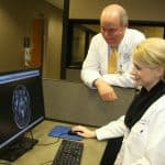 Two doctors look at brain scan