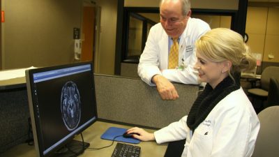 Two doctors look at brain scan