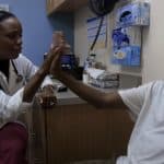 Dr. Nadine Burke Harris chats with a patient in a scene from the documentary “Resilience.”