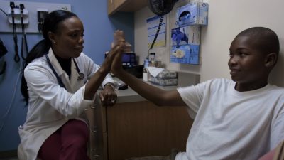 Dr. Nadine Burke Harris chats with a patient in a scene from the documentary “Resilience.”