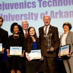Winners of the Governor’s Cup business plan competition are (l-r): team members Joshua Phillips, Tiffany Jarrett and Amanda Stolarz. They are joined by (back left) Rush Deacon, CEO, Arkansas Capital Corporation; Gov. Asa Hutchinson, Carol Reeves, team adviser, and Kevin Burns, chairman of the board, Arkansas Capital Corporation.
