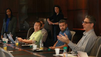 Scientists in discussion at a table