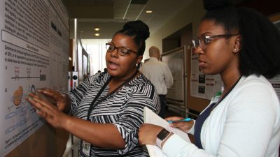 Two students at poster