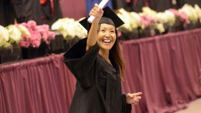 Student waves diploma