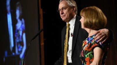 Chancellor with arm around wife