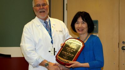 Two scientists with plaque