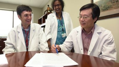 UAMS’ Craig Forrest, Ph.D., (left), credits his former mentors, Usha Ponnappan, Ph.D., and Xuming Zhang, Ph.D., D.V.M., with his early success.