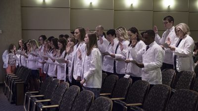 The Physician Assistant Class of 2019 recites the PA Professional Oath after the students received their white coats during a May 26 ceremony.