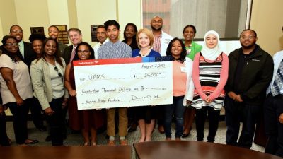 Students who took part in the Center for Diversity Affairs' summer enrichment programs pose with center staff and Bank of America representatives Donnie Cook (back row, fifth from left) and Heather Albright (front row, holding check).