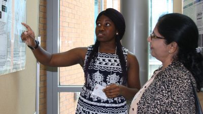Student at poster explaining research