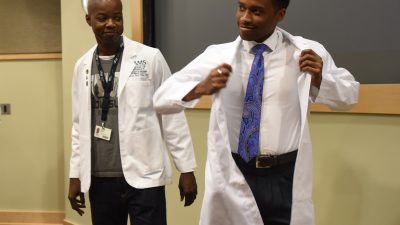 Professor and student with white coats