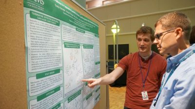 Dustyn Barnette, a third-year graduate student, discusses his research with Jason Stumhofer, Ph.D.
