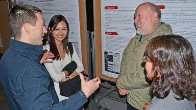 Group talking near poster