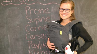 Researcher with baby dummy in carrier