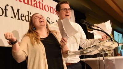 Couple smiling at mic