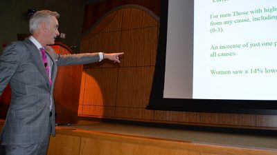 Timothy Harlan, M.D., points at the screen to emphasize a point during his presentation at the 23rd annual Diabetes Update Symposium.