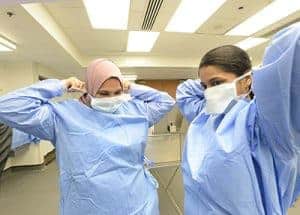 Two attendees put on masks before participating in a hands-on workshop at Kidney Con.