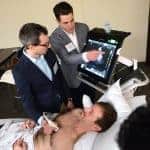 Kidney Con attendees practice using ultrasound technology with help from a standardized patient during a workshop.