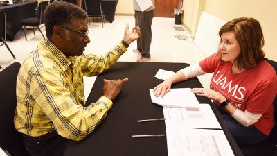 Patrick Pettus, left, talks with a volunteer at March Man-ness at Saint Mark Baptist Church. It was the second year Pettus attended the annual event.