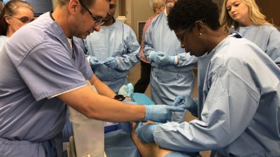 Doctors practing knee injections