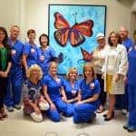 El Dorado artist Melinda Cameron-Godsey (fourth from right) celebrated the installation of her painting titled "Hope" at the UAMS Winthrop P. Rockefeller Cancer Institute. She is joined by Liudmila Schafer, M.D. (third from right); daughter Courtney Cassinelli (far left); friends; and oncology nurses.
