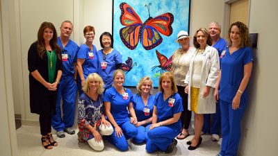 El Dorado artist Melinda Cameron-Godsey (fourth from right) celebrated the installation of her painting titled "Hope" at the UAMS Winthrop P. Rockefeller Cancer Institute. She is joined by Liudmila Schafer, M.D. (third from right); daughter Courtney Cassinelli (far left); friends; and oncology nurses.